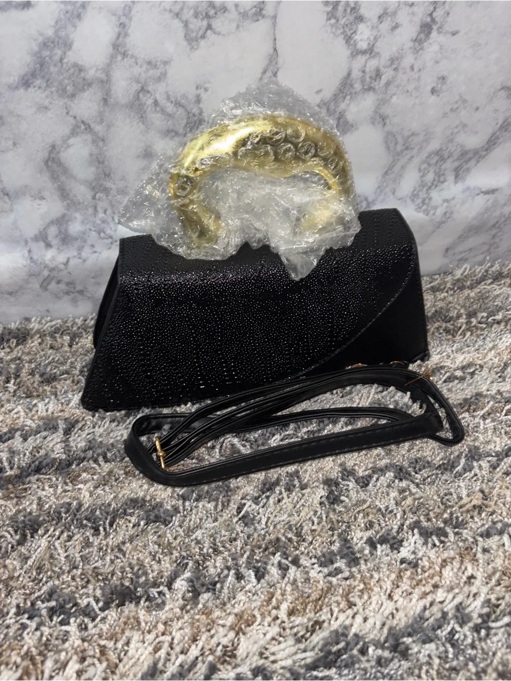 Elegant Black Textured Clutch with Gold Accent Handle